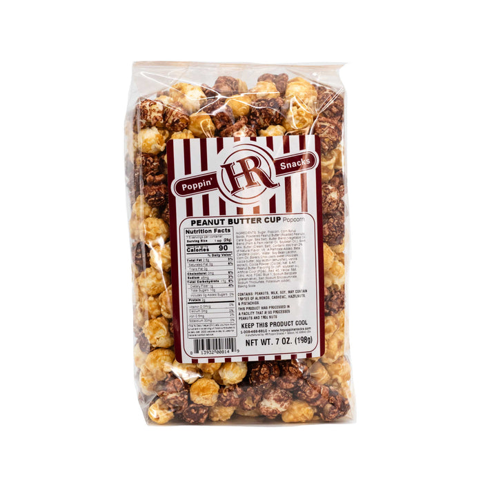 A pack of HR Poppin' Snacks gourmet popcorn labeled 'Peanut Butter Cup' flavored, showing the popcorn inside the transparent packaging and the brand's branding on the label.